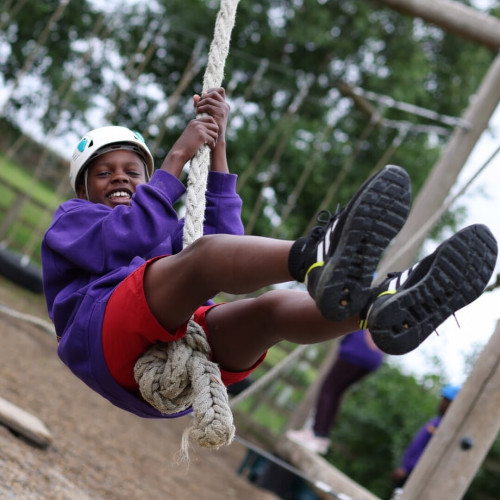Boy swinging on rope